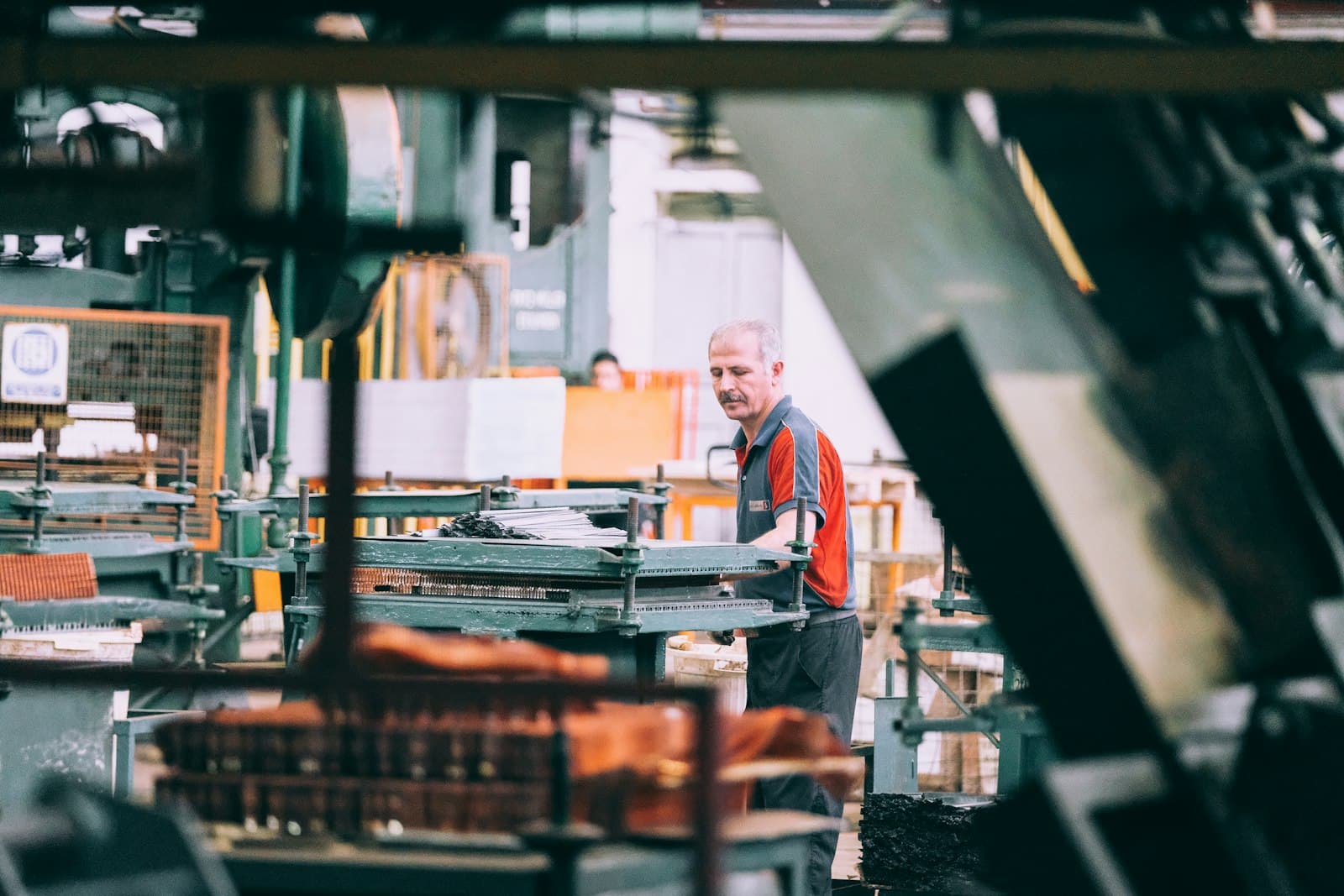 Worker on a factory production line reviewing equipment